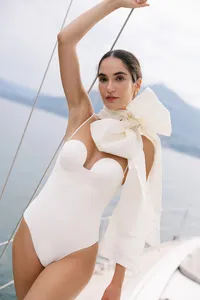 Model wearing white fashion bow piece during Lake Como bridal fashion editorial