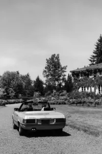 Bride and groom driving away in classic car after private estate wedding in Vancouver, Washington.