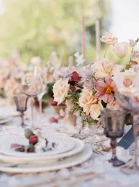 Blush floral centerpiece and table setting at Sunstone Winery wedding reception.