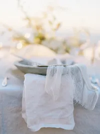 Close-up of wedding table with textured linen and neutral styling