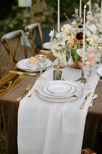 garden wedding table setting with layered plates and gold flatware