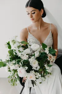 Bride holding blush and white garden rose bouquet at private estate wedding in Vancouver, Washington.