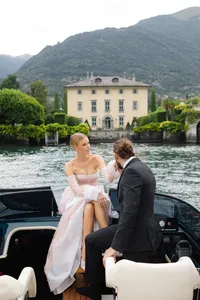 Couple arriving by boat at a lakeside villa in Lake Como