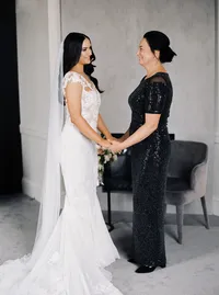 Bride and mother of the bride holding hands during an intimate preparation moment before the Lake Oswego Oregon winery wedding.