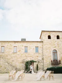 Outdoor ceremony chairs with flowing silk aisle decor at Sunstone Winery wedding.