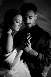 Editorial black and white portrait of a couple in a close embrace