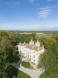 Aerial view of Château des 3 Fontaines surrounded by trees