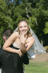 Bride and groom laughing together in a green garden