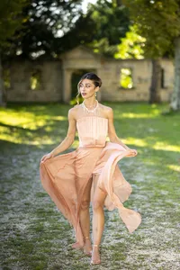 Bride in her gown in a sunlit garden
