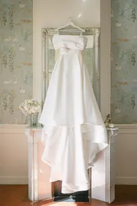 Wedding dress hanging by the window during the preparations