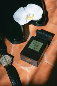 Groom’s cologne and accessories laid out during the preparations