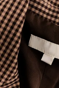 kaboompics_gingham-blazer-label-inside-lining-and-care-tag-detail-42419