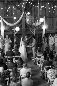 barn wedding ceremony under the lights in vermont