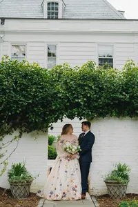 bride and groom posing in front of venue