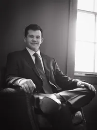 groom posing before walking down the aisle to get married