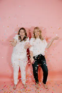 Nicole and Dylan, mother-daughter Salesforce strategists, posing playfully against a pink background.