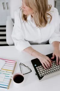 Woman typing on a computer while learning Salesforce skills and preparing for a new career.
