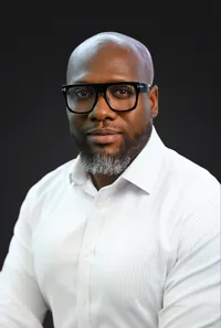 Studio portrait of a banking executive, confident pose, neutral backdrop