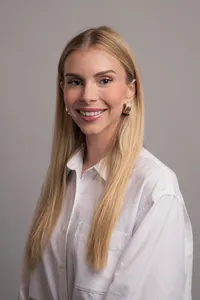 Studio portrait of a marketing executive, subtle smile, professional attire