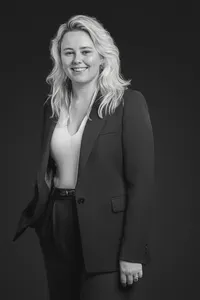 Blakc and white studio portrait of a lawyer with a confident pose, neutral backdrop