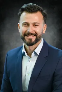 Professional portrait of a business employee, relaxed pose, grey studio backdrop