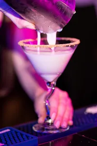 An espresso martini being poured into a glass