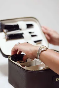 dg collaboratives make up bag, Daniella hand leaning in with Rolex watch