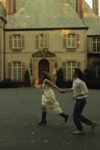 Couple running in front of a mansion in Newport, RI