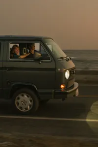 Couple driving along Ocean Drive in Newport, RI