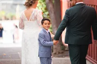 Newlyweds and kid holding hands during a natural light wedding photography session by Lauren Ford Photography in Orange County