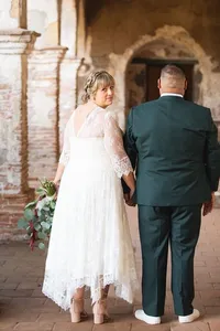 Bride looking back while holding her husbands hand during a natural light wedding photography session by Lauren Ford Photography in Orange County