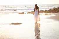 Senior girl at the beach during a golden hour graduation photo session in Orange County