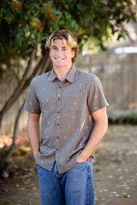 High school boy senior smiling during a graduation photo session in Orange County