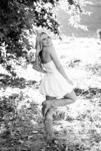 Senior girl smiling on a black and white graduation photo session in Orange County