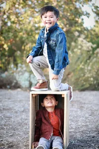 Siblings playing outside during a family photography session in Orange County