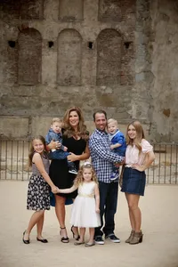 parent and five kids smiling during a family photography session in Orange County