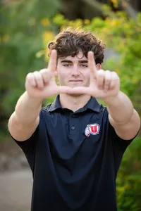 High school graduate smiling during a graduation photo session in Orange County
