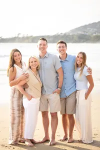 Family smiling and embracing during a family photo session in Orange County