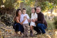 Parents and children smiling during a family photography session in Orange County