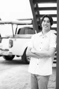 boy smiling during a graduation photo session in Orange County