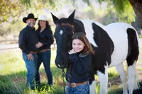 Parents, kid and horse during a family photography session in Orange County
