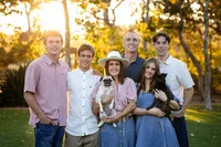 Family and pug during an outdoor family photo session in Orange County