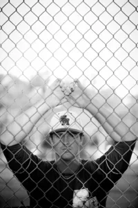 Baseball player graduate during a graduation photo session in Orange County