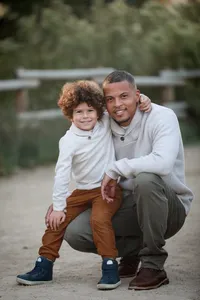 Father and son smiling during a family photography session in Orange County