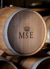 Detailed photograph of a new Oak barrel with the Château Malescot St. Exupéry logo embossed on the front.