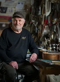 Environmental portrait of a guitar maker in the Brook Guitars workshop, photographed by Simon Moore.