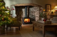 Aspect 7 wood-burning stove in a Christmas interior with seasonal decorations.