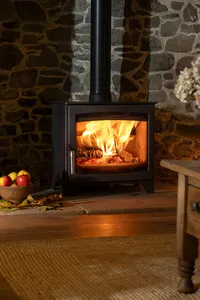 Aspect 7 wood-burning stove in a Christmas interior with seasonal decorations.