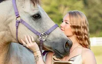 Professional photography by Nature's Child Photography: High school senior sharing a tender moment with her gray horse in Middleburg, highlighting her passion for riding during a personalized outdoor senior portrait experience.
