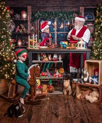 Children dressed as elves playing with toys while visiting Santa’s Workshop during a Christmas photography session in Jacksonville, Florida with Nature’s Child Photography, surrounded by wooden toys, glowing lanterns, and cozy North Pole magic.